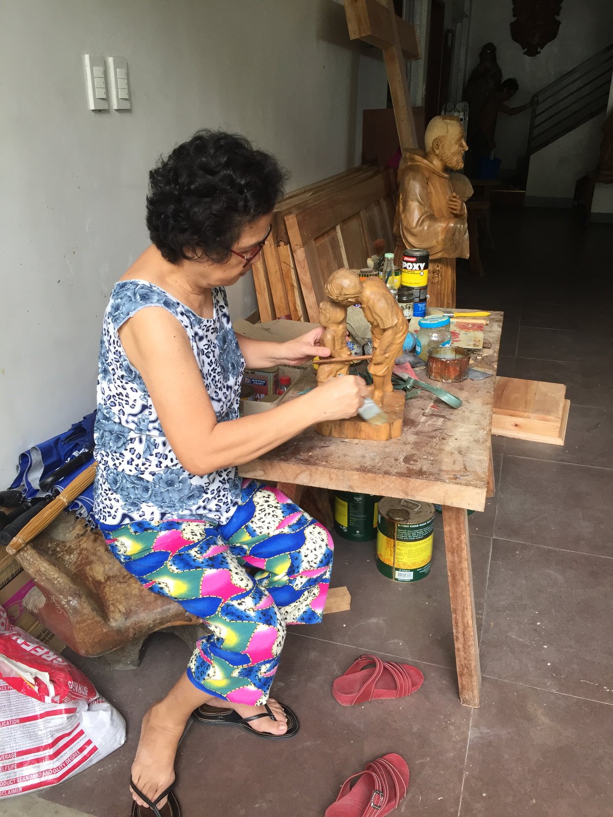 Cely doing as-is on wood carvings of her husband.
